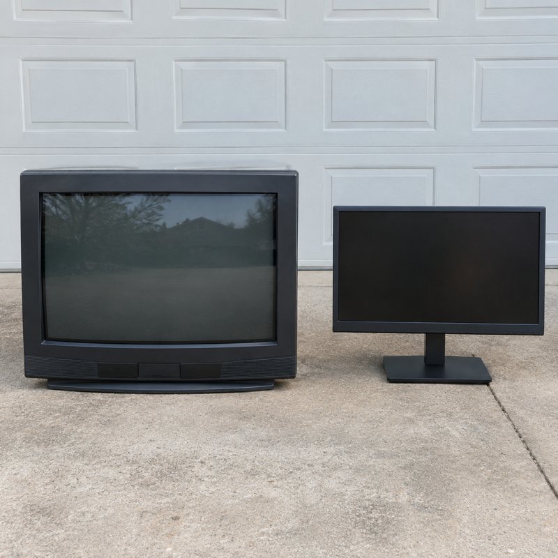 A television and monitor set beside a dump trailer